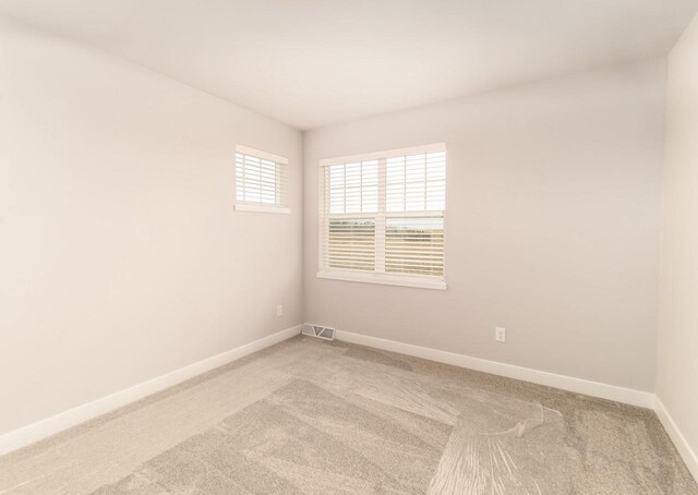 600 E Verleen Ave, Waunakee, WI 53597 - spare room with light carpet, visible vents, and baseboards
