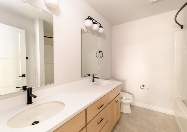 600 E Verleen Ave, Waunakee, WI 53597 - bathroom featuring toilet, double vanity, a sink, and baseboards