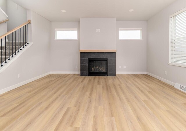 600 E Verleen Ave, Waunakee, WI 53597 - unfurnished living room featuring wood finished floors, baseboards, visible vents, and stairs