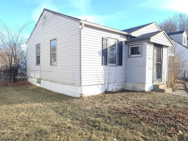 view of property exterior with a lawn