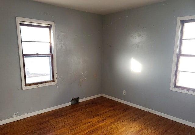 spare room featuring hardwood / wood-style flooring and a wealth of natural light