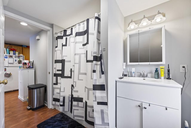 bathroom with hardwood / wood-style flooring and vanity