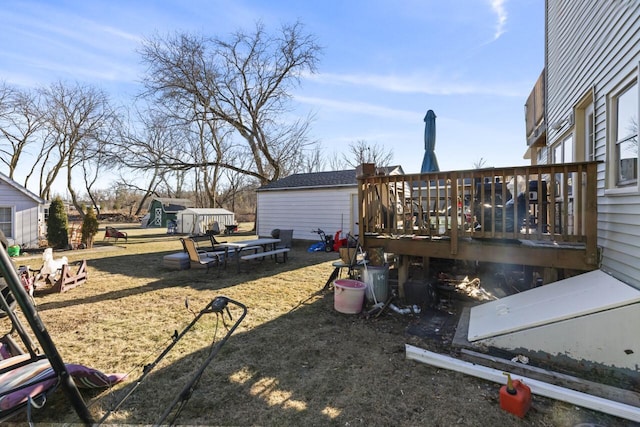 view of yard with a wooden deck and a shed