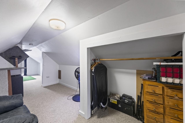 bonus room featuring vaulted ceiling and carpet flooring