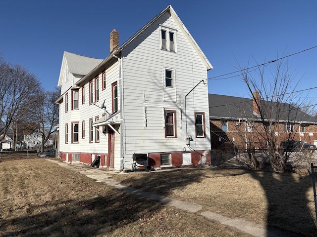 rear view of house with a yard