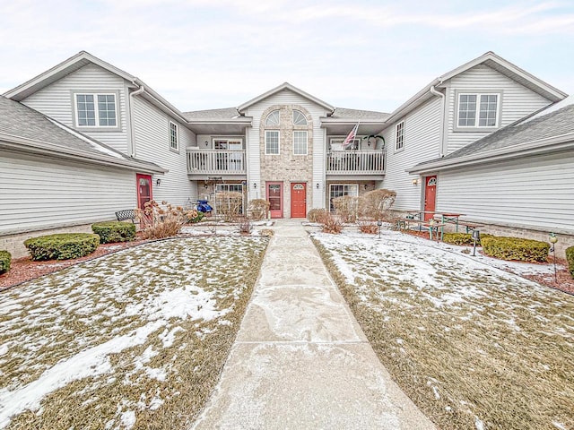 view of snow covered rear of property