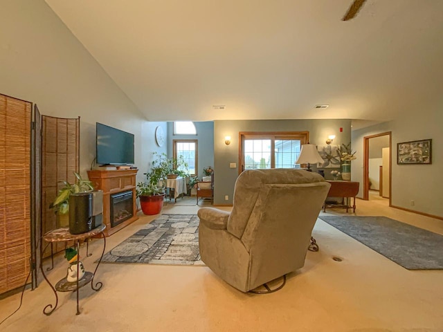 living room with high vaulted ceiling and light colored carpet