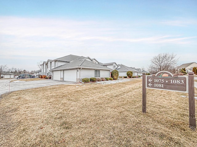 view of front of property with a garage and a front lawn