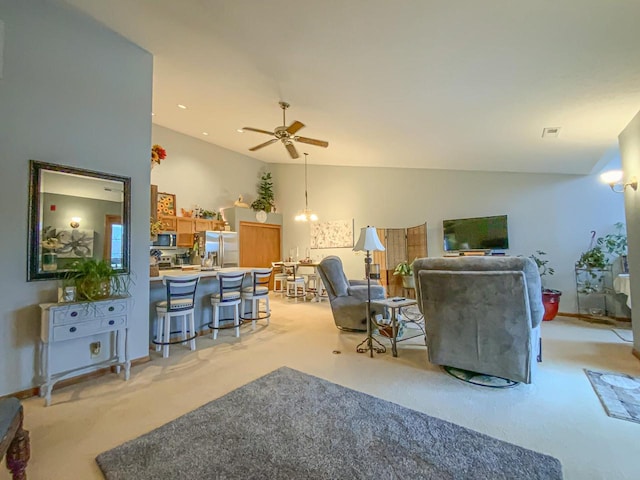 living room featuring ceiling fan and vaulted ceiling