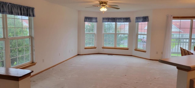 spare room featuring ceiling fan and light colored carpet