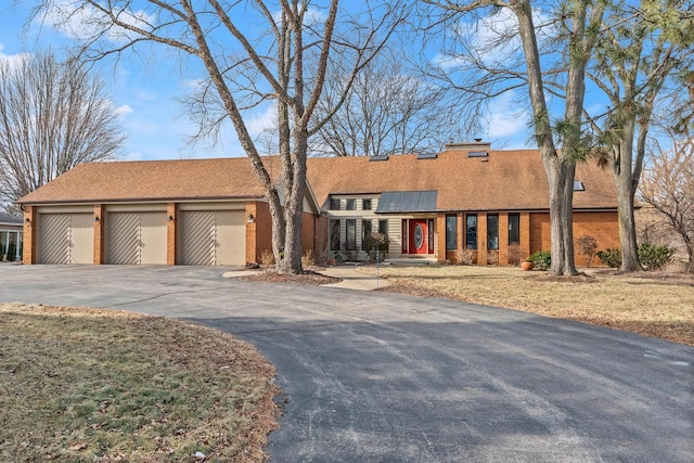 view of front of property with a garage and solar panels