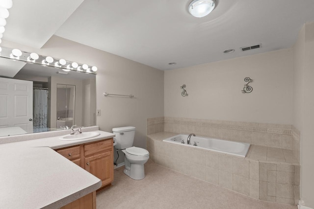 bathroom with a relaxing tiled tub, vanity, and toilet