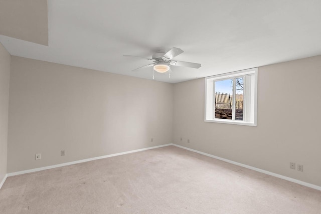 empty room featuring light carpet and ceiling fan