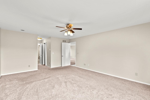 carpeted empty room featuring ceiling fan