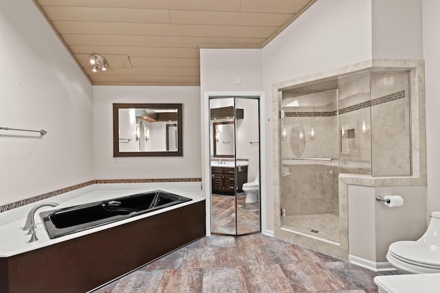 bathroom with a shower with door, vanity, lofted ceiling, and toilet