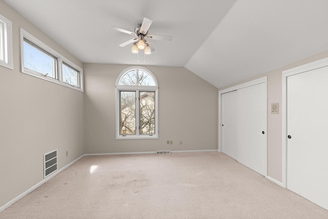 additional living space with lofted ceiling, light colored carpet, and ceiling fan