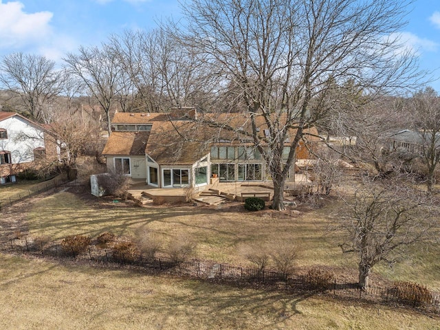 rear view of property featuring a yard