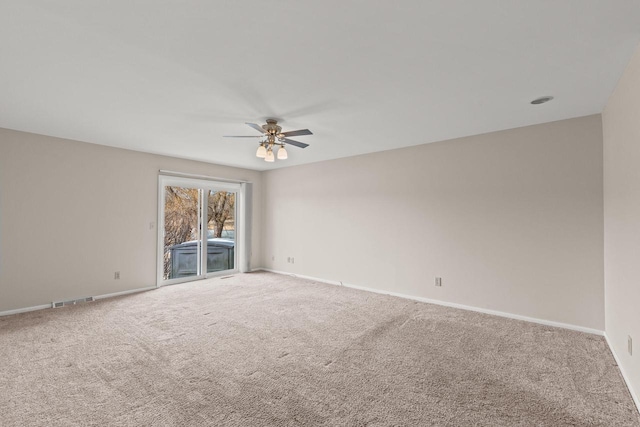 carpeted empty room featuring ceiling fan