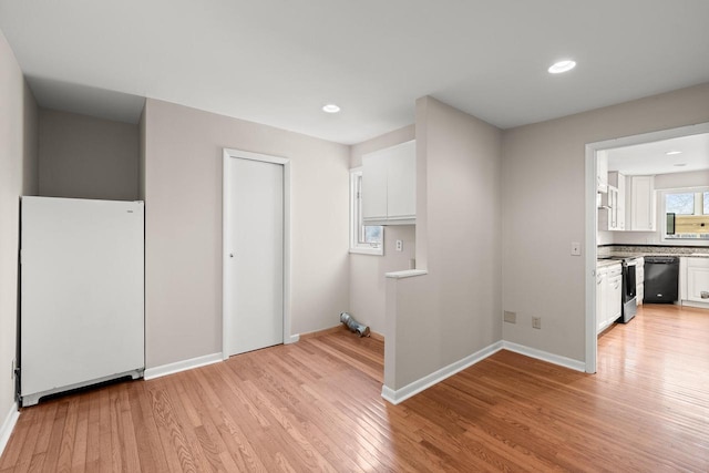 clothes washing area featuring light hardwood / wood-style floors