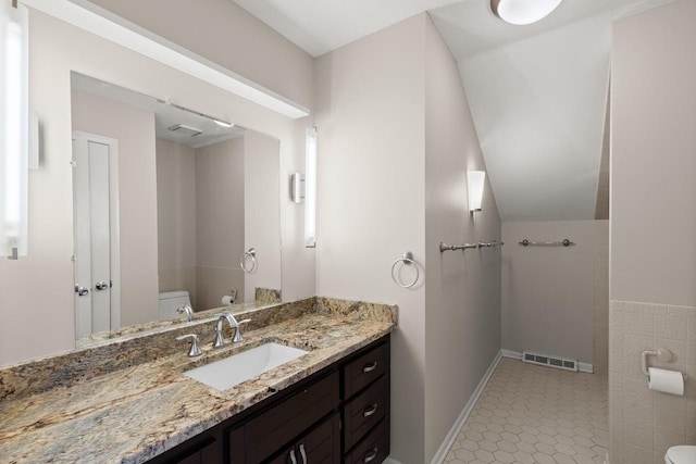 bathroom with vanity, tile patterned floors, and toilet