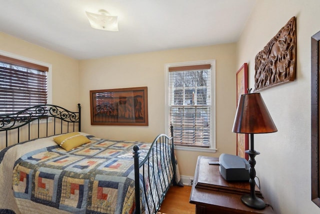 bedroom featuring baseboards and wood finished floors