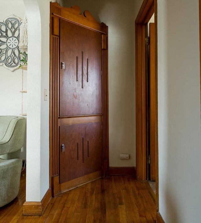 hallway with dark wood-type flooring