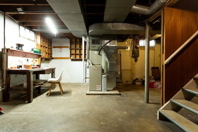 basement with heating unit and a workshop area