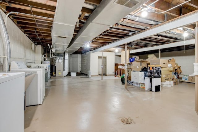 basement featuring washer and clothes dryer and heating unit