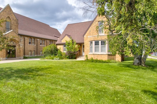 tudor-style house with a front yard