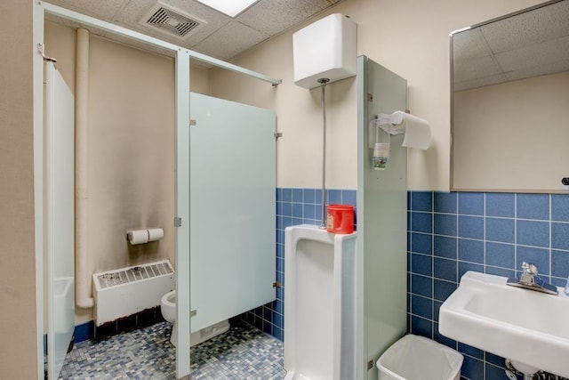 bathroom featuring a paneled ceiling, sink, tile walls, walk in shower, and a bidet