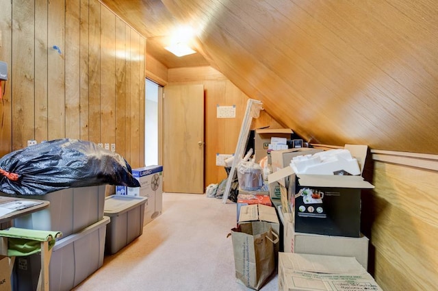 bonus room featuring lofted ceiling, carpet flooring, wood ceiling, and wood walls