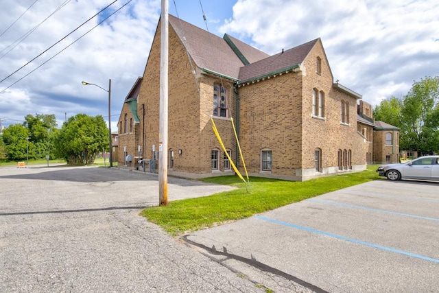 view of property exterior with a yard