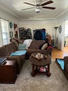 living room featuring light wood-type flooring and ceiling fan