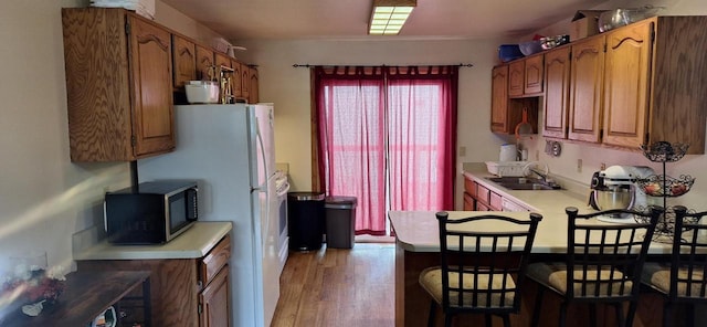 kitchen with sink and light hardwood / wood-style floors