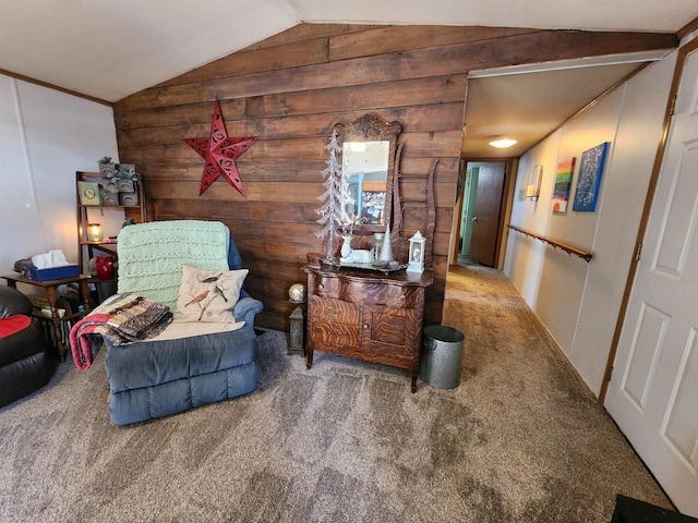 sitting room with vaulted ceiling, wooden walls, and carpet