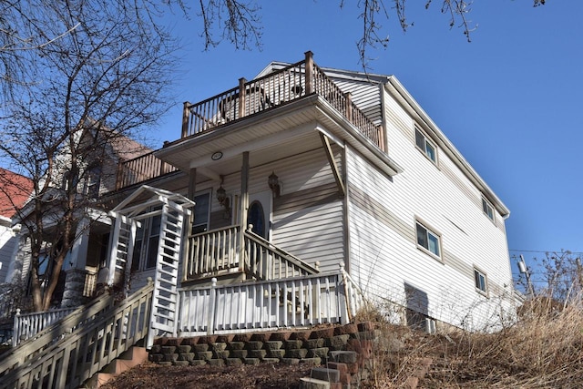 view of home's exterior with a balcony