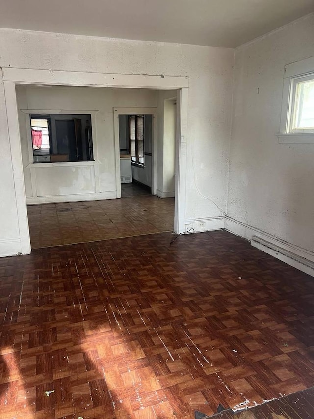 unfurnished room with dark parquet floors