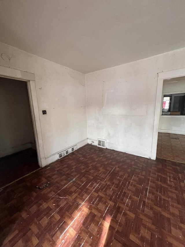 empty room with dark parquet floors