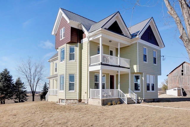 view of front of house featuring a balcony and covered porch