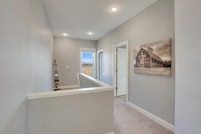 hallway featuring light carpet