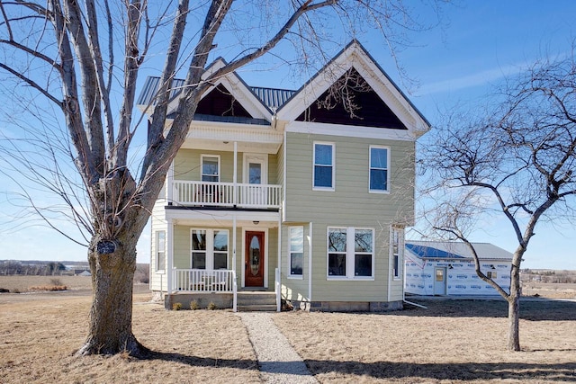 view of front of house featuring a porch and a balcony