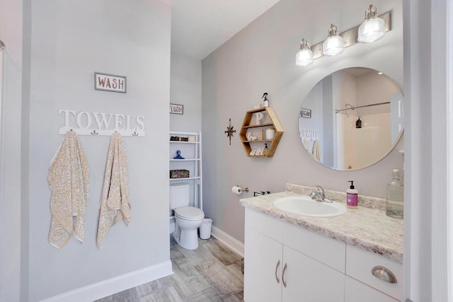 bathroom featuring vanity, hardwood / wood-style floors, a shower, and toilet