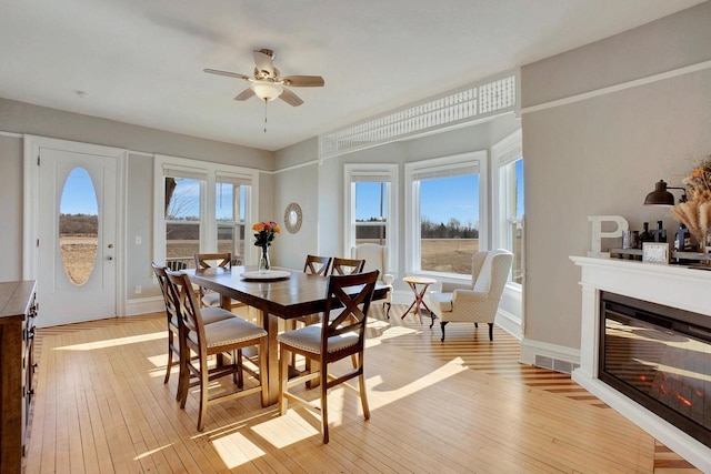 dining room featuring plenty of natural light, ceiling fan, and light hardwood / wood-style flooring