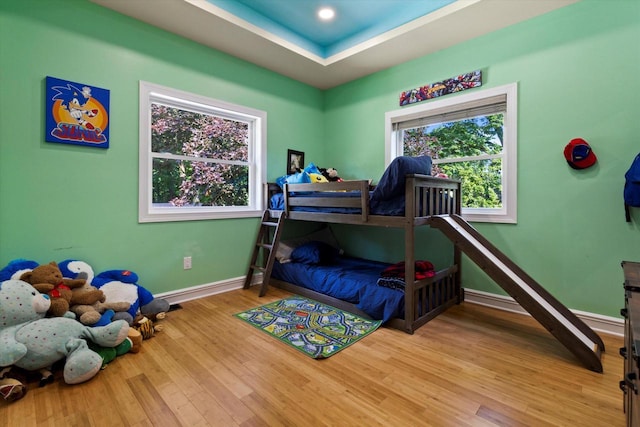 4922 W Dean Rd, Milwaukee, WI 53223 - bedroom with wood finished floors, baseboards, and a tray ceiling