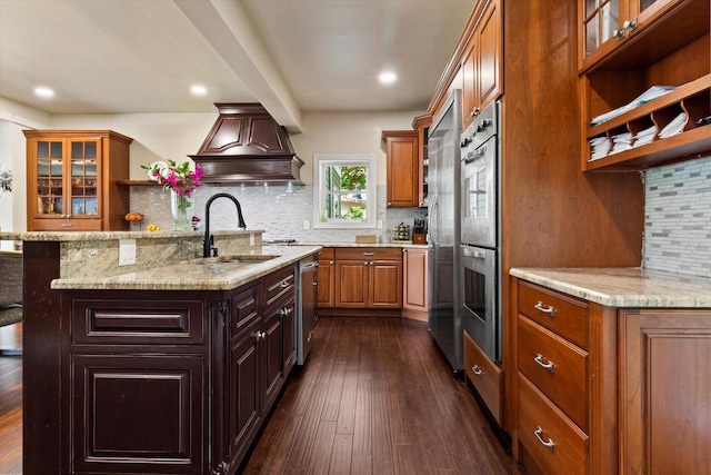 kitchen with premium range hood, dark wood-type flooring, sink, tasteful backsplash, and stainless steel appliances