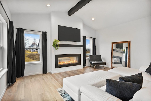 living room with lofted ceiling with beams and light hardwood / wood-style flooring