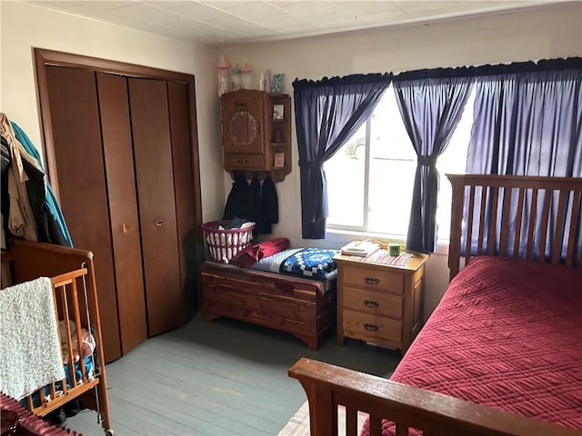 bedroom featuring hardwood / wood-style floors and a closet