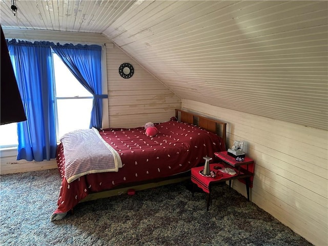 carpeted bedroom with lofted ceiling, wooden ceiling, and wood walls