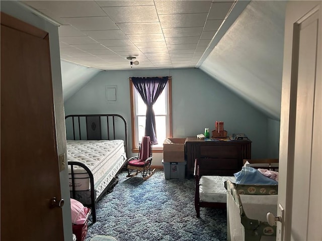 carpeted bedroom featuring lofted ceiling