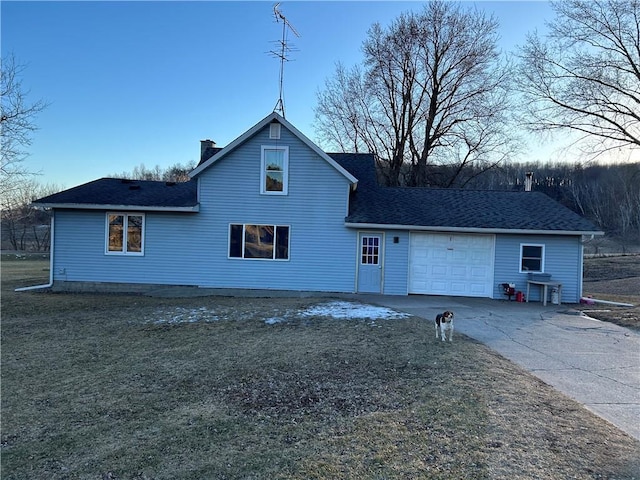 rear view of property with a garage